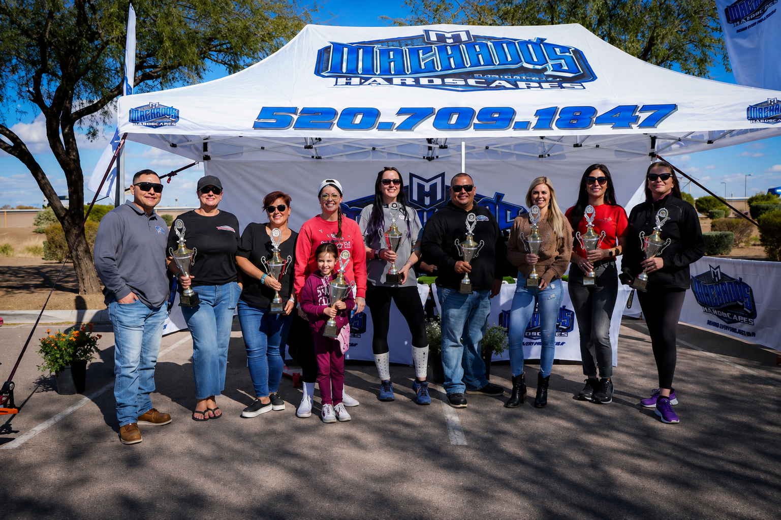 The Machado's Hardscape Construction team with their project trophies